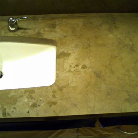 Splotchy White Etches & Burns on Brown Limestone Vanity