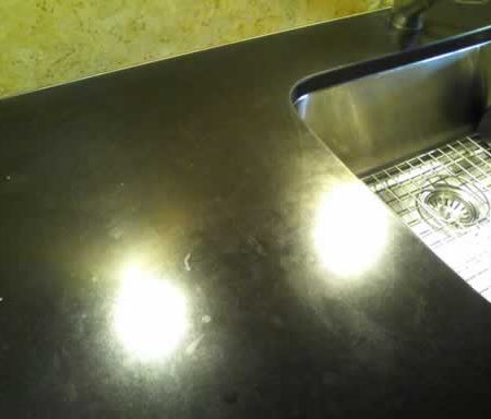 Splotchy Black Granite Counter Recession with Marks and Traces
