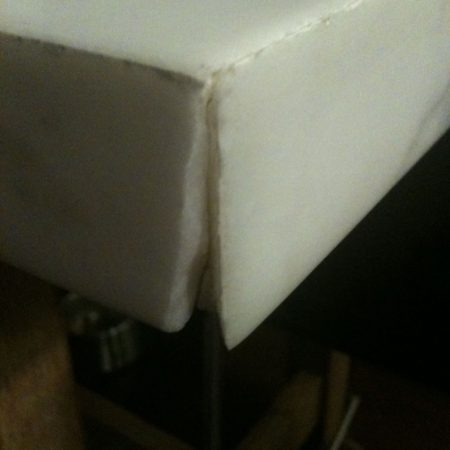 chipped table corner before image Chip Slicing Off from the Mitered Seam