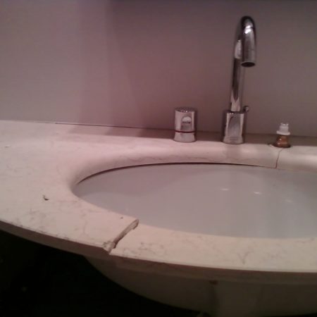 Cracked Vanity Hanging on Sink