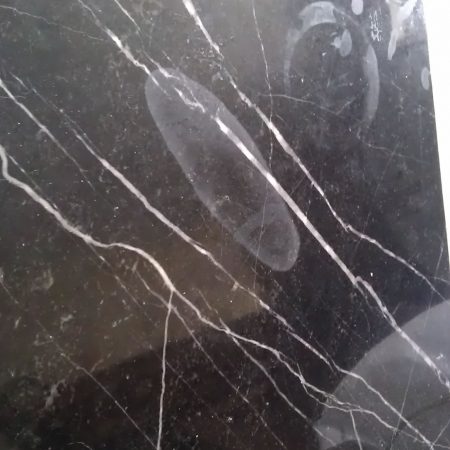 Etched Ring Marks on Black Marble Table