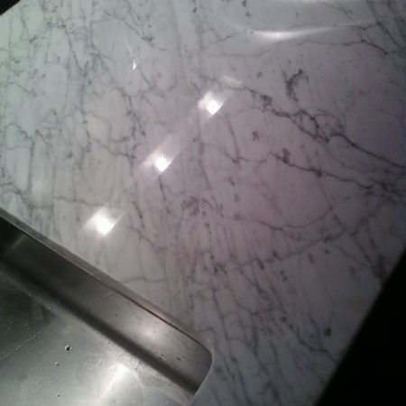 Light Reflection on White Carrara Countertop