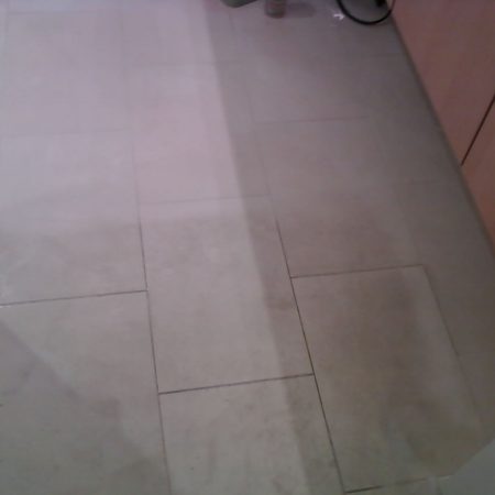 Grime Kitchen Floor. Cleaned and Not Cleaned Parts