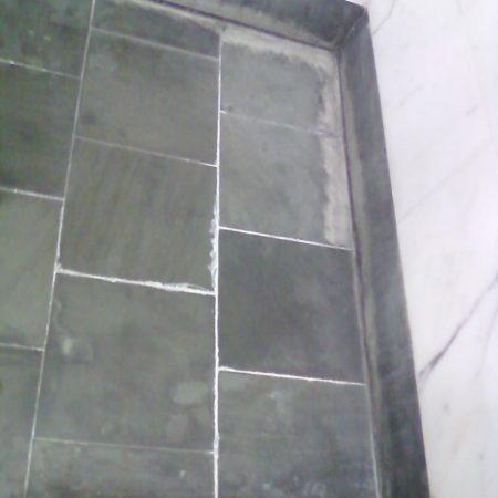 marble shower floor before image Minerals Efflorescence Buildup on Shower Floor (Before Restoration)
