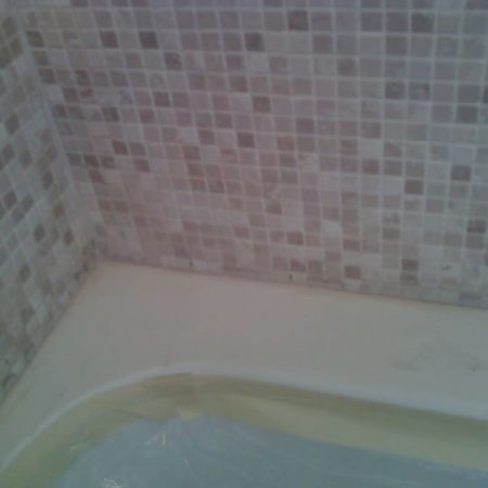 Tub and Mosaic Wall Before Recaulking