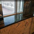 Dark marble bathroom windowsill after transparent polyester resin coating – smooth glossy mirror-like finish
