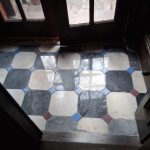 Vestibule floor with octagonal brown stone tiles after professional restoration – polished and gleaming surface