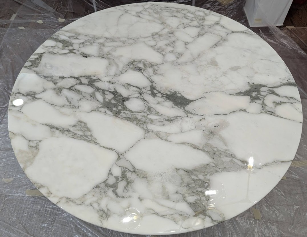 new coat applied to aged Knoll table top 47 inches High-gloss transparent epoxy coat fully applied to 47-inch Knoll Saarinen marble table top, final result