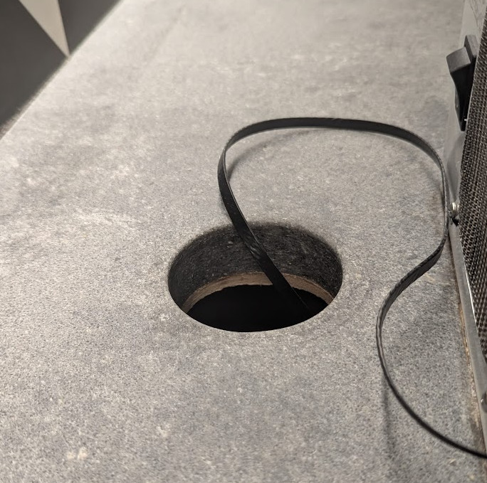 Engineered quartz countertop with 3-inch hole enlarged for airflow
