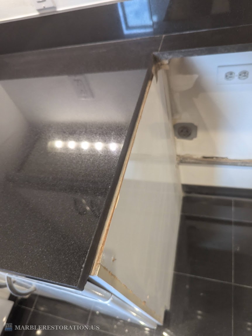 Left granite side cut for a 30 inch stove, after The left granite countertop side after the cut for a 30 inch stove, the new edge ground smooth, white cabinet side below