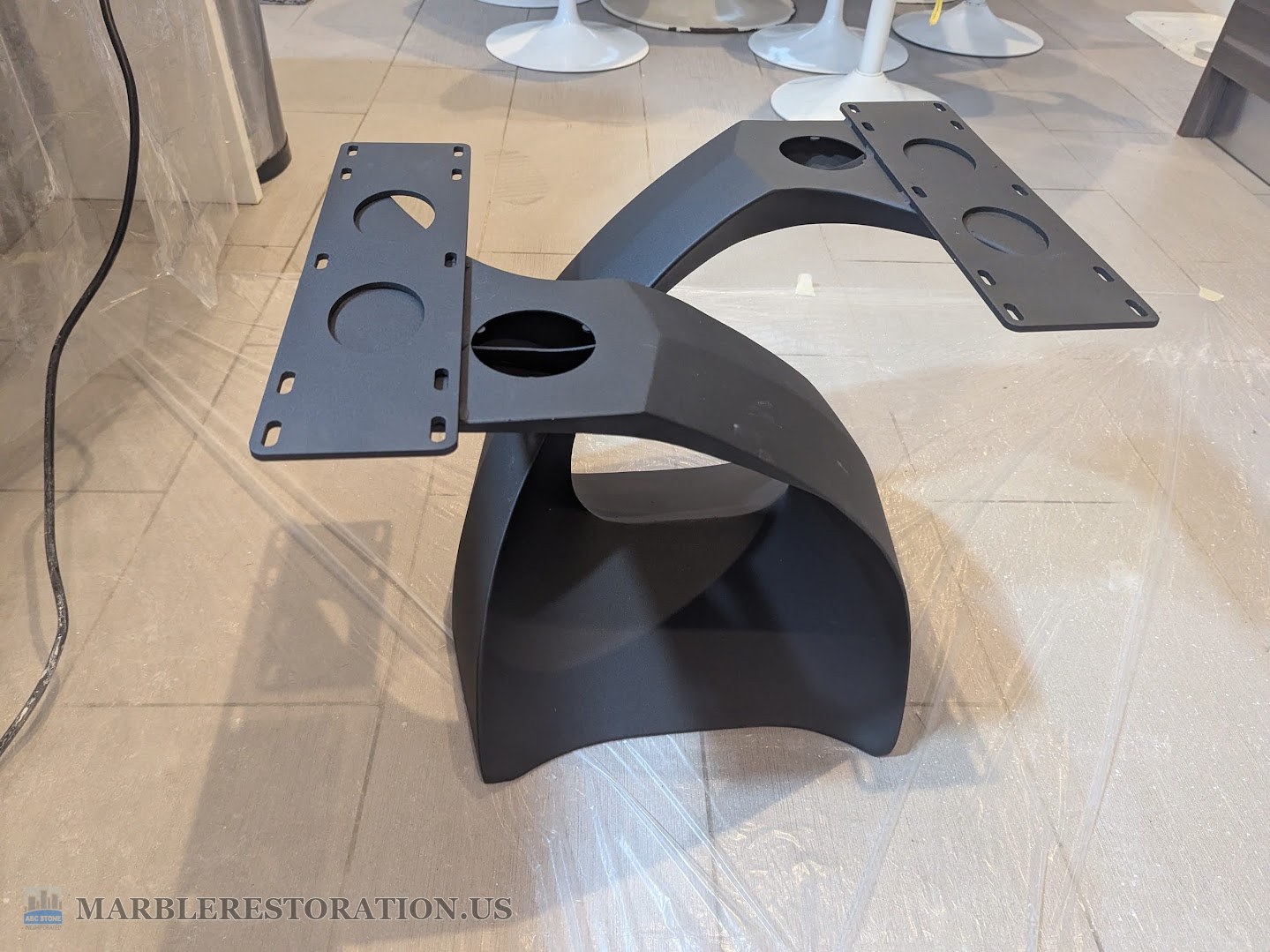 New metal leg for a marble coffee table, before the top went on New black metal coffee table leg standing on its own, two flat mounting plates on top