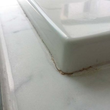 Dirty Crack on Caulk. Acrylic Bathtub