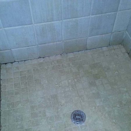 Travertine Beveled Tiles in Shower before Cleaning