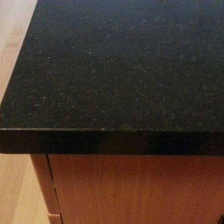 Black Granite with Gray Crystals. Chip after Repair