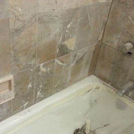 Pale Erosion on Marble Walls above Bathtub