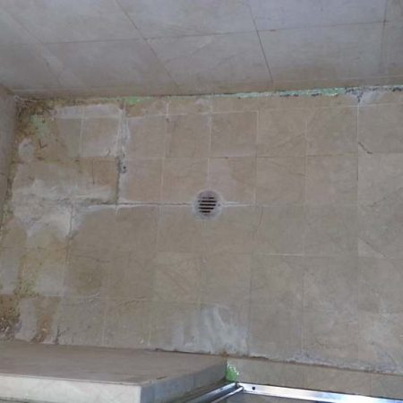 Shower Deterioration and Deep Erosion on Shower Floor