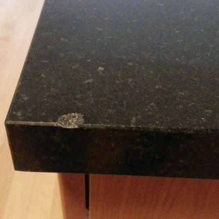 Chip on Black Granite With Gray Crystals