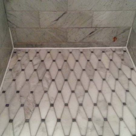 Marble Shower Floor with White Caulk on Perimeter