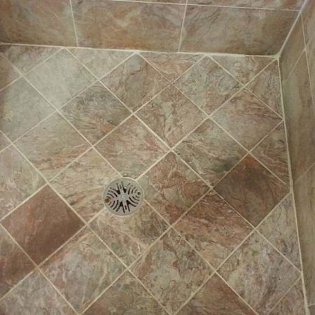 Deeply Eroded Shower Stall Floor