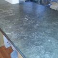 Severely Spotted Etched Burned Limestone Countertop