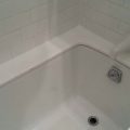 White Glass Bathtub Top After Recaulking